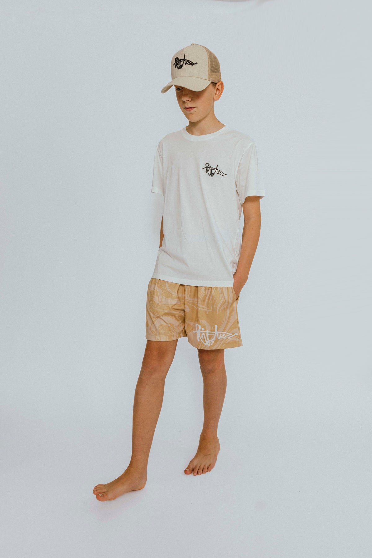 Lifted "Cream" Shorts worn lifestyle shot, warm cream swim shorts
