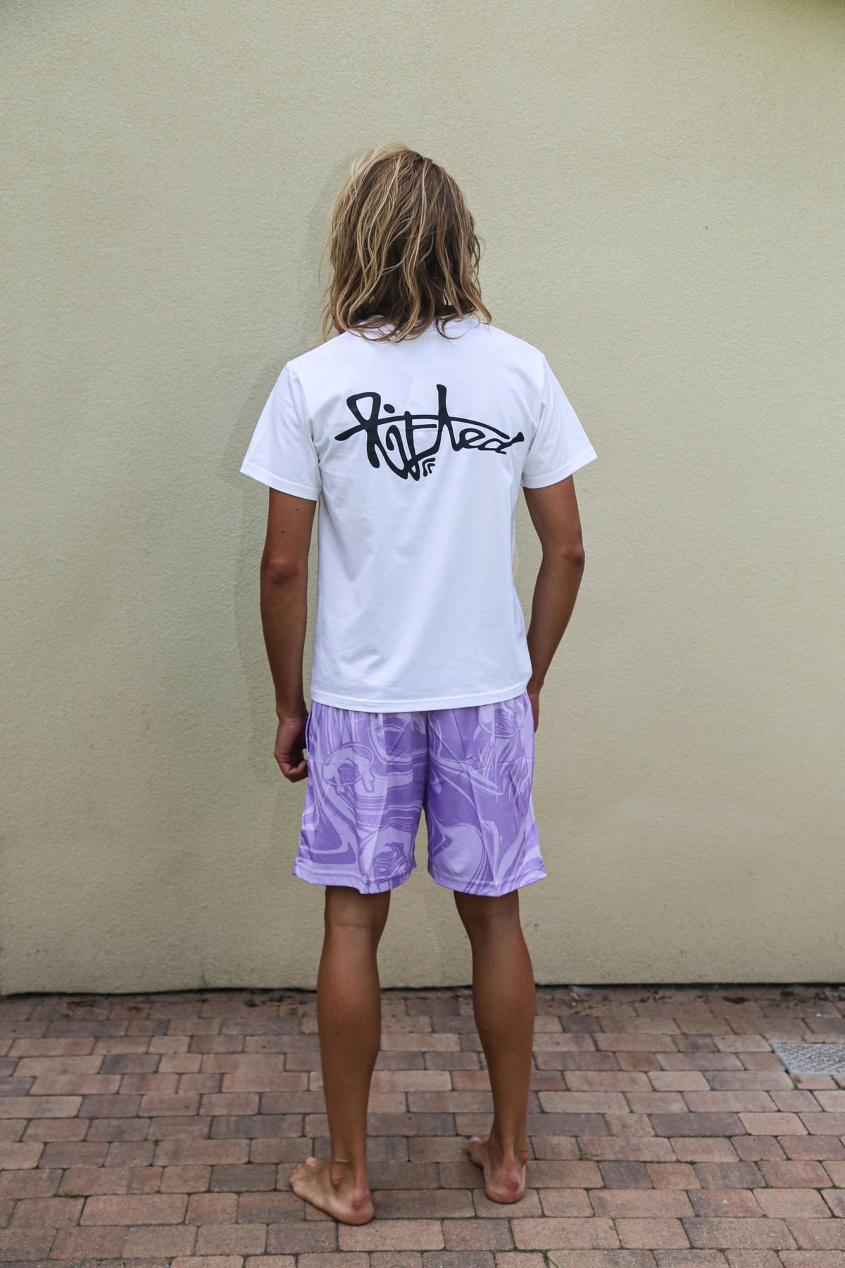 Lifted "Amethyst" Shorts lifestyle shot on model, amethyst purple swim shorts