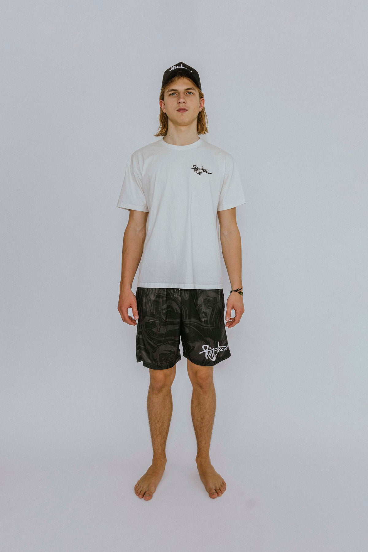 Lifted "Onyx" Shorts lifestyle shot on model, black swim shorts